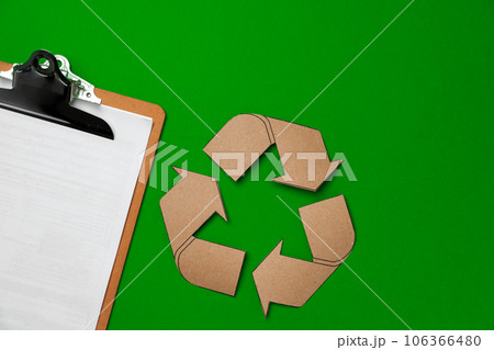 Paper recycling concept on green background top view 106366480