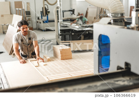 Young man doing woodwork in carpentry factory Young man doing woodwork in carpentry factory 106366619