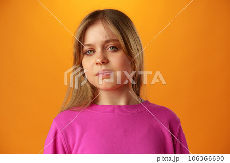 Upset disturbed teen girl on yellow background 106366690