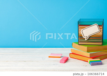 Stacked books on wooden desk front view 106366714