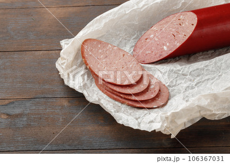 Chopped meat sausage on wooden board close up 106367031