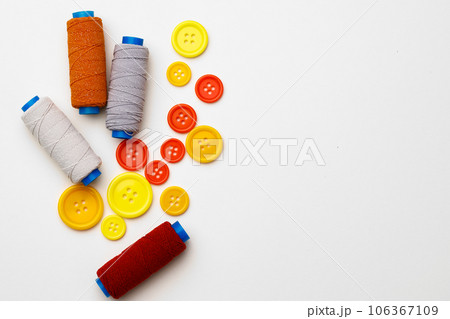 Colored spools of threads on white background 106367109