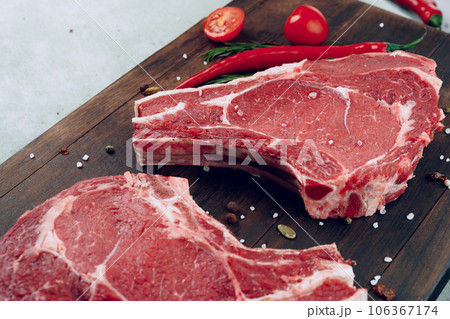 Raw beef meat fillet on wooden board 106367174