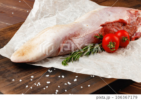 Raw beef tongue on dark wooden board Raw beef tongue on dark wooden board 106367179
