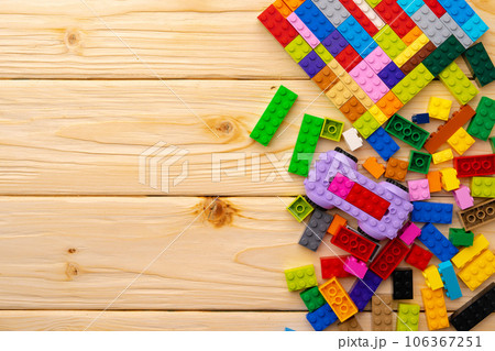 Toy constructor details on wooden background close up 106367251