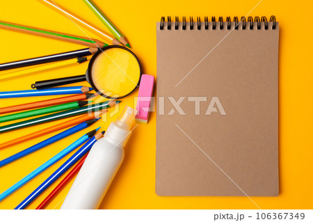 Notepad and color pencils on working space top view 106367349