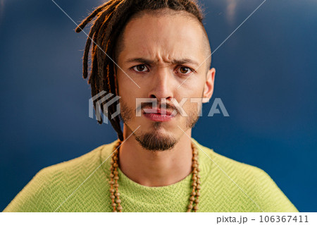 Close-up portrait of a young stylish man with dreadlocks 106367411