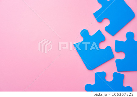 Blue puzzle pieces on paper background top view 106367525