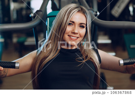 Young blonde woman fitness coach doing hands workout Young blonde woman fitness coach doing hands workout 106367868