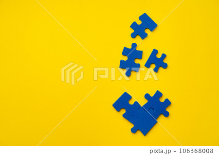 Blue puzzle pieces on paper background top view Blue puzzle pieces on paper background top view 106368008