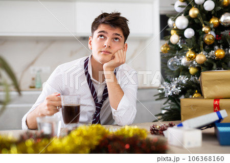 man suffering while hungover after new year party man suffering while hungover after new year party 106368160