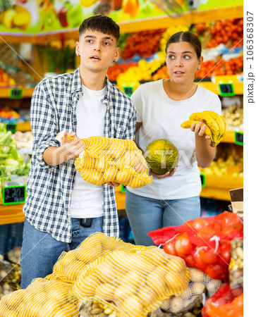Happy young couple chooses products 106368307