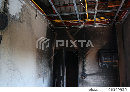 old scary interior burn house, cement wall and wood floor 106369936