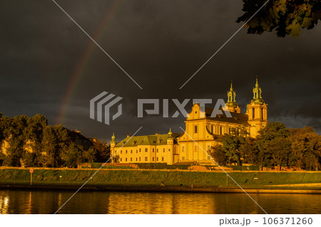 Heavy rain and rainbow above the Vistula river in Krakow Poland. Stunning views of the city rainy season and rainbow 106371260