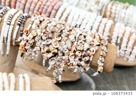 Bracelets made of colorful shells are in souvenir shop 106373435