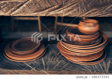Clay plates, collection and demonstration in a workshop, small business and retail store. Clay products, on a shelf in a studio, creative store or production startup. High quality photo Clay plates, collection and demonstration in a workshop, small business and retail store. Clay products, on a shelf in a studio, creative store or production startup. High quality photo 106373591
