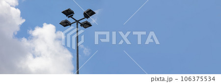 In the panoramic view, a street light lantern against a sky covered with white clouds. 106375534