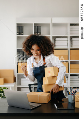 Small business entrepreneur SME freelance African woman working at home office, BOX,tablet and laptop online, marketing, packaging, delivery,  e-commerce concept 106377658