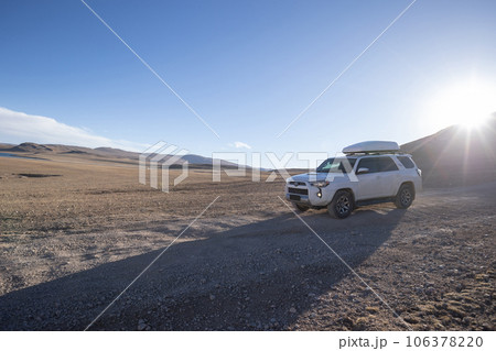 Driving off road car on the high altitude mountain slope 106378220