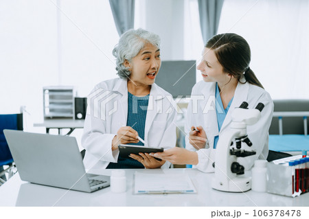 Scientist team meeting and writing analysis results in the laboratory study and analyze scientific sample, test samples 106378478
