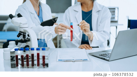 Scientist team meeting and writing analysis results in the laboratory study and analyze scientific sample. Scientist team meeting and writing analysis results in the laboratory study and analyze scientific sample. 106378532