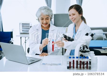 Scientist team meeting and writing analysis results in the laboratory study and analyze scientific sample, test samples 106378534