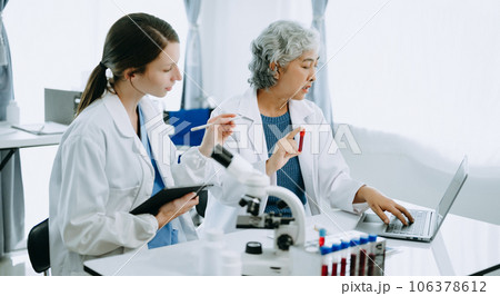 Scientist team meeting and writing analysis results in the laboratory study and analyze scientific sample, test samples Scientist team meeting and writing analysis results in the laboratory study and analyze scientific sample, test samples 106378612