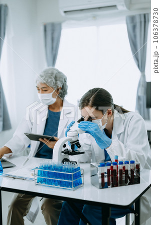 Scientist team meeting and writing analysis results in the laboratory study and analyze scientific sample, test samples 106378730