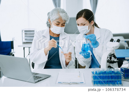 Scientist team meeting and writing analysis results in the laboratory study and analyze scientific sample, test samples Scientist team meeting and writing analysis results in the laboratory study and analyze scientific sample, test samples 106378734