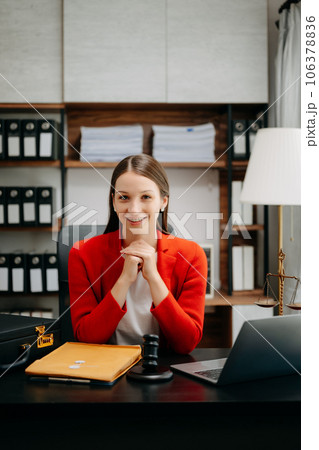 justice and law concept. Female judge in a courtroom the gavel, working with smart phone and laptop and digital tablet computer on black table justice and law concept. Female judge in a courtroom the gavel, working with smart phone and laptop and digital tablet computer on black table 106378836