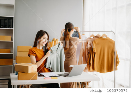 Fashion blogger concept, Young Asian women selling clothes on video streaming.Startup small business SME, using smartphone or tablet taking receive and checking. Fashion blogger concept, Young Asian women selling clothes on video streaming.Startup small business SME, using smartphone or tablet taking receive and checking. 106379575