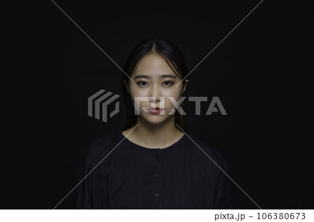 黒背景の若い女性のポートレート 106380673