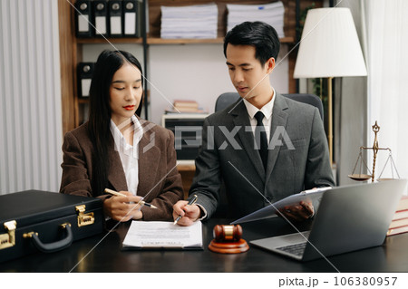 Asian business team and lawyers discussing contract papers sitting at the table. Concepts of law, advice, legal services. at modern office Asian business team and lawyers discussing contract papers sitting at the table. Concepts of law, advice, legal services. at modern office 106380957