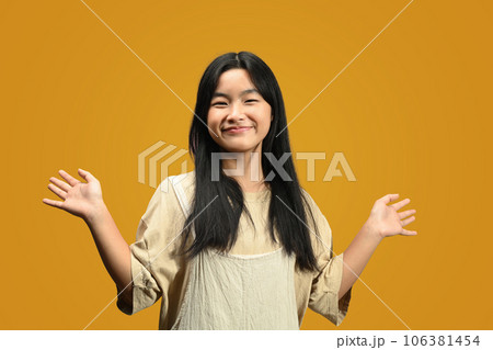 Cute Asian teenage girl wearing casual clothes posing isolated on yellow background 106381454