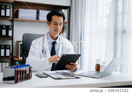 Medical technology concept. Asian Doctor working with mobile phone and stethoscope in modern office 106381582