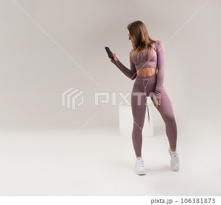 sexy athletic girl in a tight fitness tracksuit on a light background copy paste in the studio sexy athletic girl in a tight fitness tracksuit on a light background copy paste in the studio 106381873