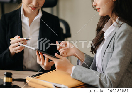 business people and lawyers discussing contract papers sitting at the table. Concepts of law, advice, legal services. in morning light. business people and lawyers discussing contract papers sitting at the table. Concepts of law, advice, legal services. in morning light. 106382681
