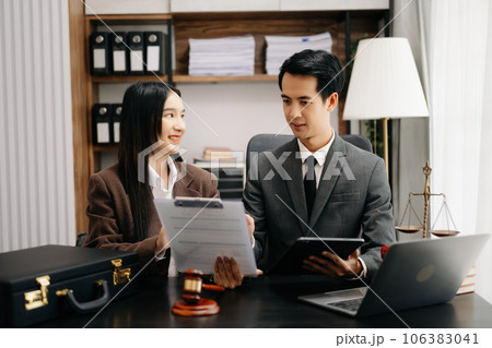 Asian business team and lawyers discussing contract papers sitting at the table. Concepts of law, advice, legal services. at modern office 106383041