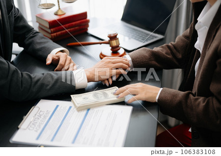 Business people compassionately holding hands and discussing contract papers with laptop and tabletat office .. Business people compassionately holding hands and discussing contract papers with laptop and tabletat office .. 106383108