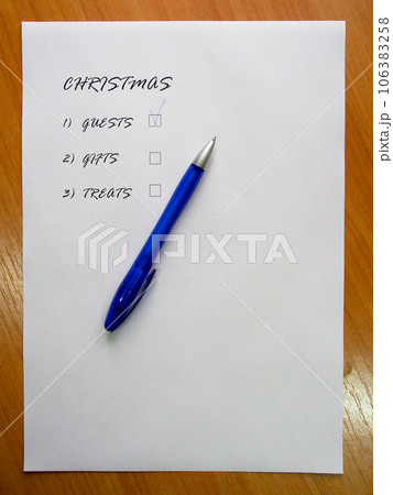 Checklist of new year holidays, text on a white sheet of paper next to a blue pen. 106383258