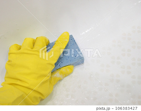 Photo hands in a bright rubber glove washing sponge home plumbing, close-up. Housework and maintenance of cleanliness is the main concept of maintenance. 106383427