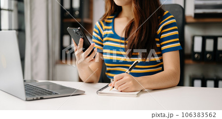 businesswoman hand working with new modern computer and writing on the notepad strategy diagram as concept . 106383562