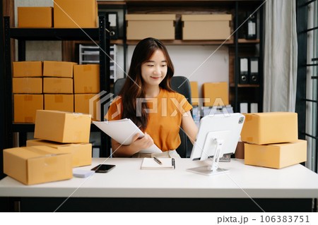 Fashion blogger concept, Young Asian women selling clothes on video streaming.Startup small business SME, using smartphone or tablet taking receive and checking. Fashion blogger concept, Young Asian women selling clothes on video streaming.Startup small business SME, using smartphone or tablet taking receive and checking. 106383751