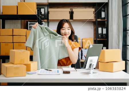 Fashion blogger concept, Young Asian women selling clothes on video streaming.Startup small business SME, using smartphone or tablet taking receive and checking. Fashion blogger concept, Young Asian women selling clothes on video streaming.Startup small business SME, using smartphone or tablet taking receive and checking. 106383824