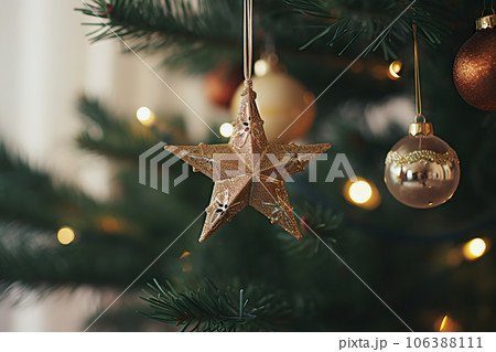 Close-Up of Modern Decorated Christmas Tree with Vintage Star, Baubles, and Golden Lights - Stylish Ornaments in Festive Room.. created with Generative AI 106388111