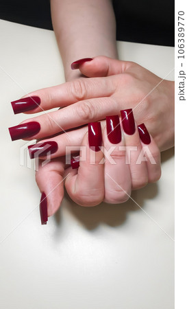 Acrylic nail extension, manicure, nail correction, hands in the foreground. Bright design. Acrylic nail extension, manicure, nail correction, hands in the foreground. Bright design. 106389770