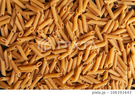 Raw Brown Pasta, Wholegrain Penne, Dry Whole Grain Noodle, Raw Spelt Macaroni, Healthy Italy Food Raw Brown Pasta, Wholegrain Penne, Dry Whole Grain Noodle, Raw Spelt Macaroni, Healthy Italy Food 106391643