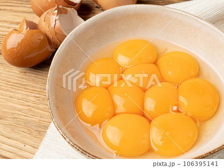 Egg Yolks in Bowl, Fresh Chicken Egg Yolk Separated from Whites for Cooking Recipe, Organic Yolks Top View Egg Yolks in Bowl, Fresh Chicken Egg Yolk Separated from Whites for Cooking Recipe, Organic Yolks Top View 106395141