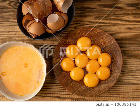 Egg Yolks in Bowl, Fresh Chicken Egg Yolk Separated from Whites for Cooking Recipe, Organic Yolks Top View 106395143