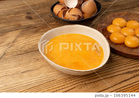 Beaten Egg Yolks in Bowl, Fresh Chicken Eggs for Cooking 106395144